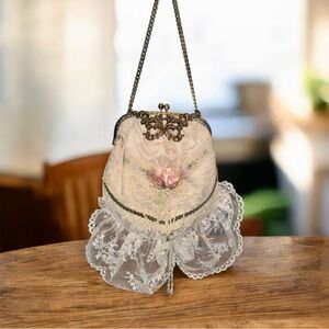 Ivory Lace Carpet Bag with Antique Hardware and pink roses.